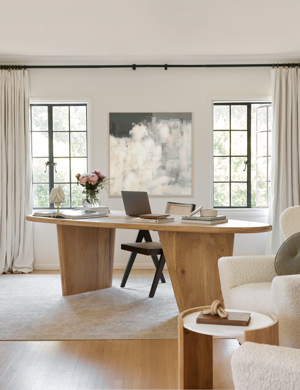 #size::26--x-26-- #size::32--x-32-- #size::38--x-38-- #size::42--x-42-- #size::49--x-49-- #frame-option::framed #color::natural | The Rina abstract netural gray toned Wall Art with a brushstroke texture sits in an office with a woven dining chair, an oval wooden dining table, and white boucle accent chairs